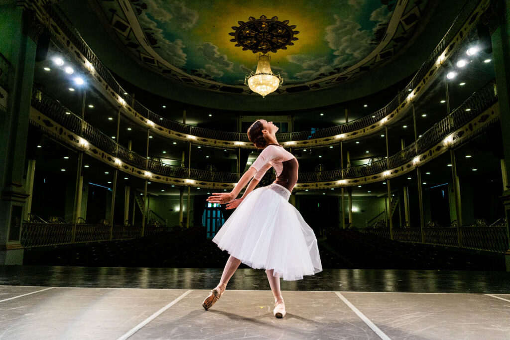 Young ballerina rehearsing on a stage theater